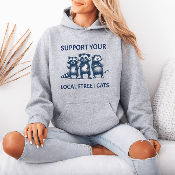 Nothing says “community support” like two raccoons and a possum banding together for the greater good (or maybe just snacks).